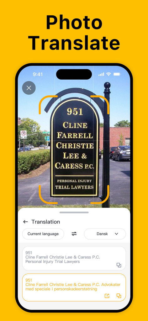 A smartphone interface showing the photo translation feature of the QR scanner app translating a sign into Danish.