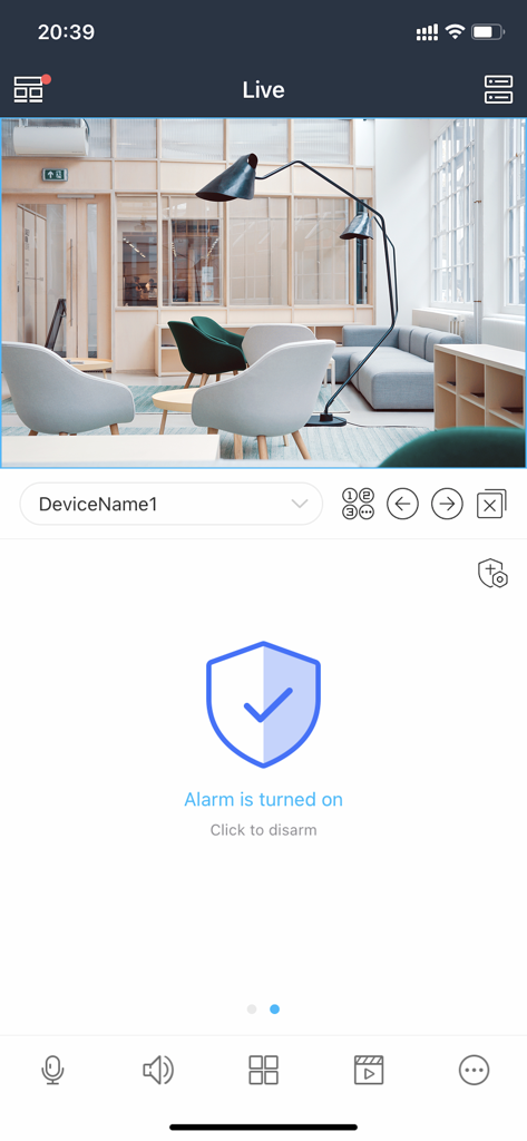 Mobile app interface showing live security camera feed of a modern office and alarm status