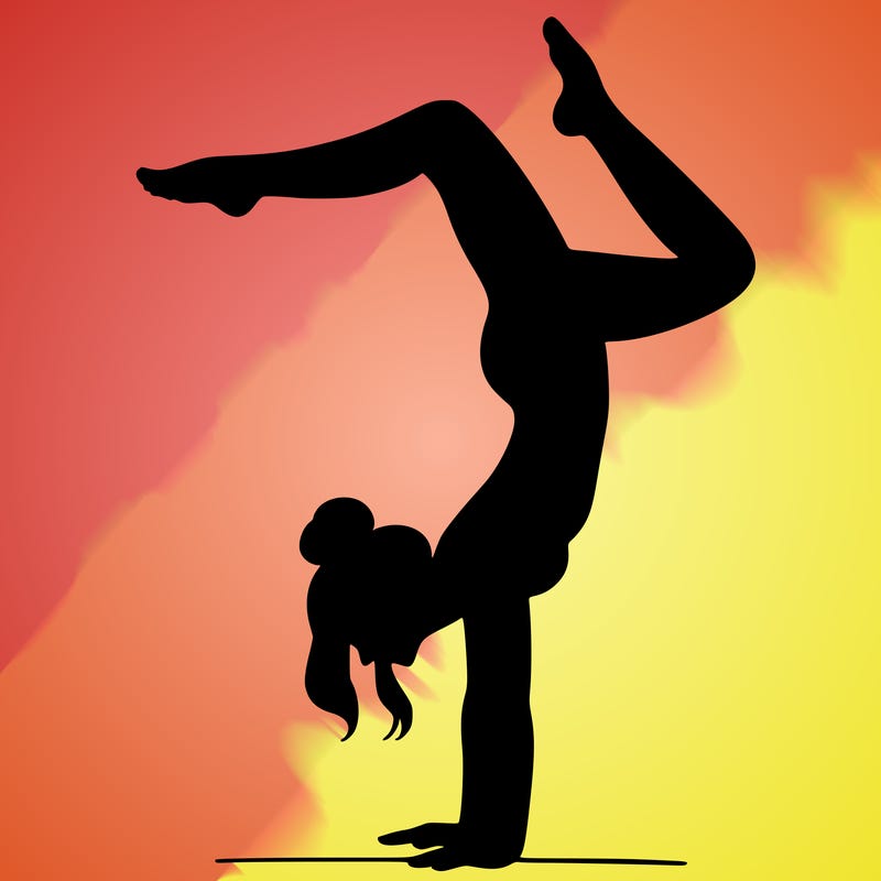 a woman doing a handstand