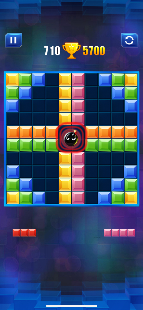 A colorful 10x10 block puzzle grid with a bomb icon in the center