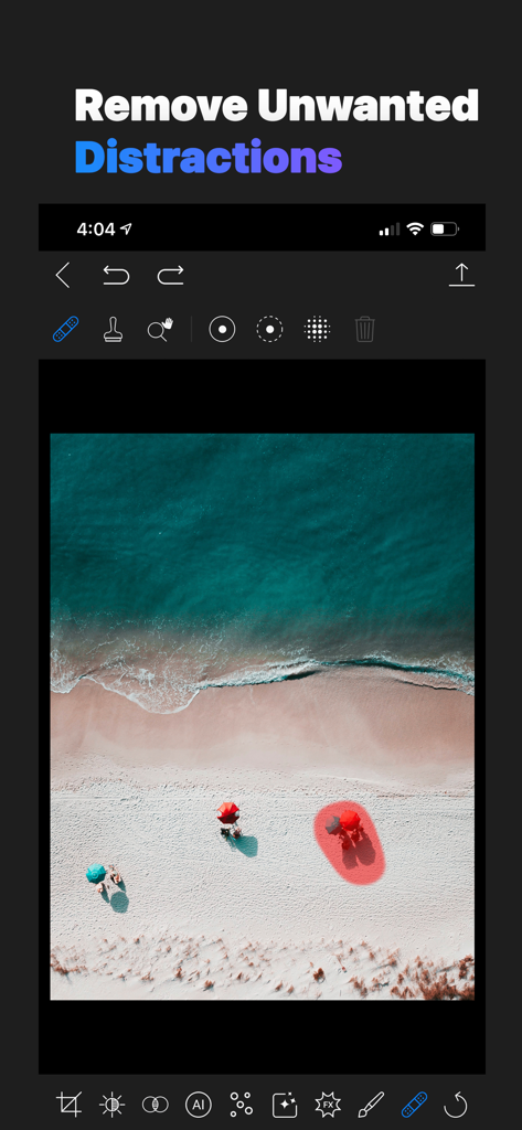 A photo editing interface showing the retouch tool being used to select and remove an umbrella from a beach landscape photo.