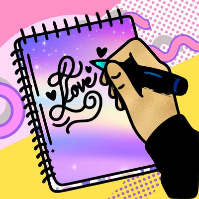 a hand writing “love” in calligraphy on a notebook