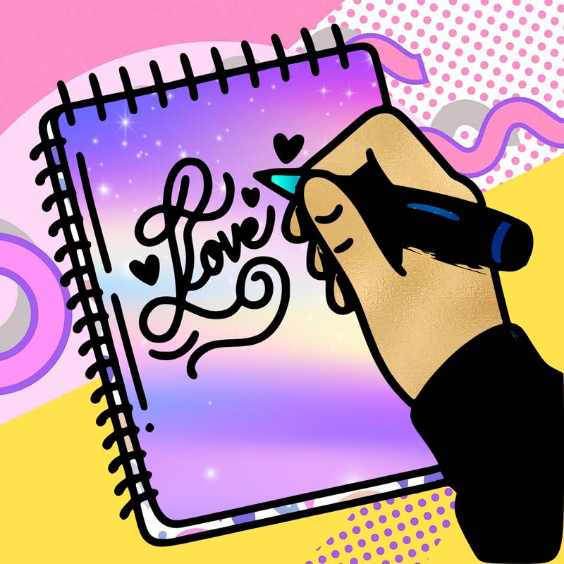 a hand writing “love” in calligraphy on a notebook