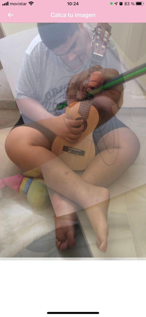 Calca app - A person using the Calca app to trace a photo of a boy playing a guitar using the camera lucida transparency feature