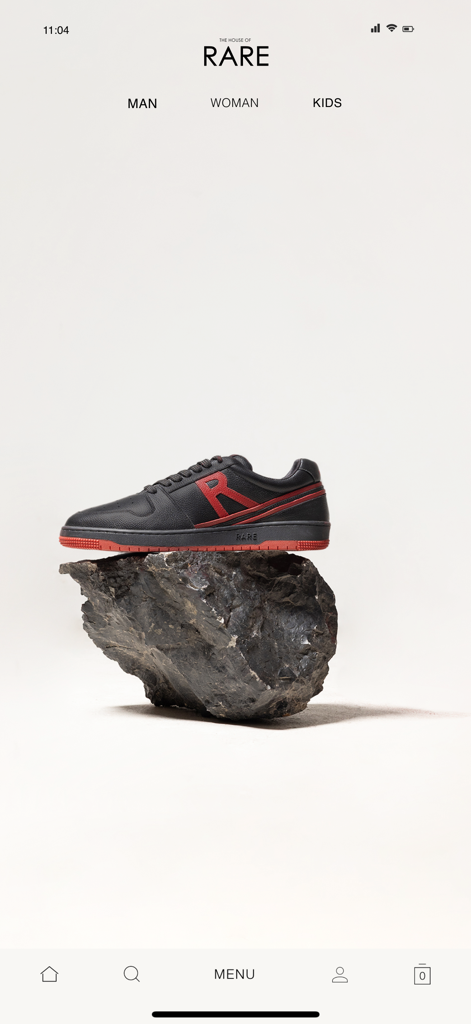 HOUSE OF RARE - A black and red premium sneaker displayed on a rock within the House of Rare mobile shopping app