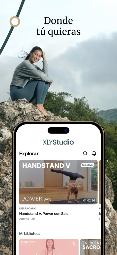 Xuan Lan Yoga y Bienestar - Woman sitting on a rock above a smartphone displaying the XLYStudio yoga app explore screen