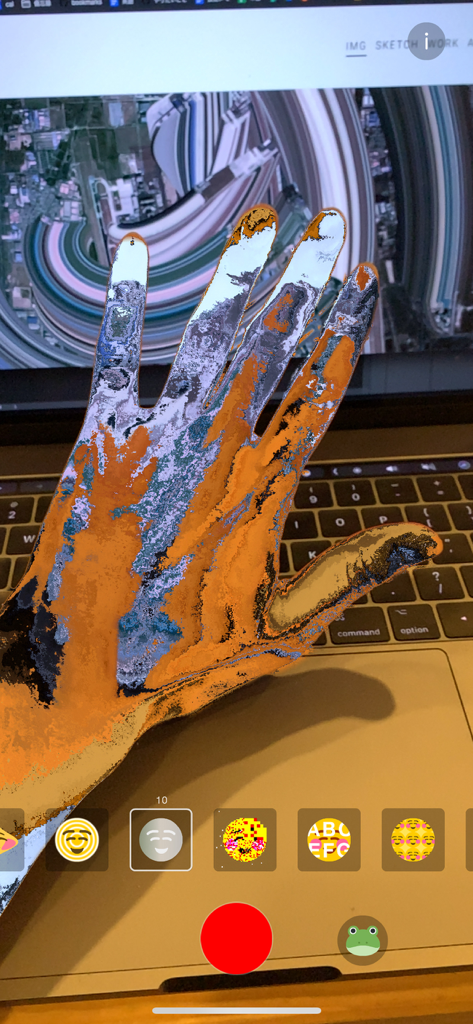 MEISAI - AR Filter - An iPhone screen showing a hand with a textured orange and blue AR glitch filter applied to its silhouette.