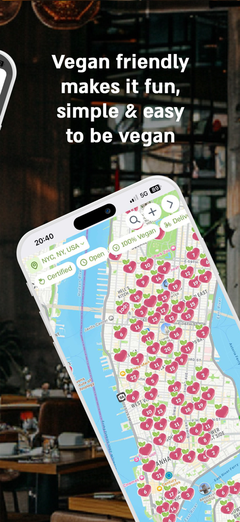 Vegan Friendly - Smartphone displaying the Vegan Friendly app map with multiple pink heart markers indicating plant based restaurants in New York City