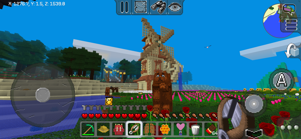 A sandbox game scene in MultiCraft featuring a large wooden windmill and a flower field.