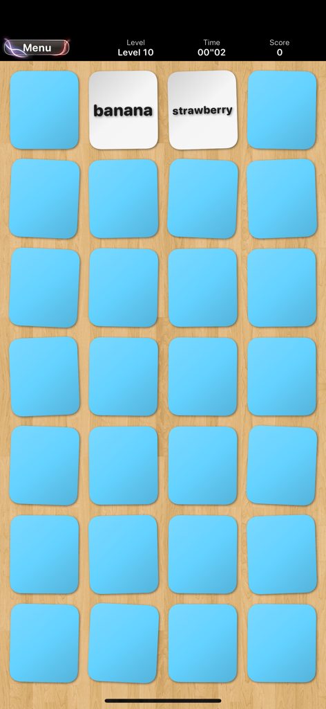 Gameplay screen of Memory Classic showing a card grid with banana and strawberry words revealed on a wooden background