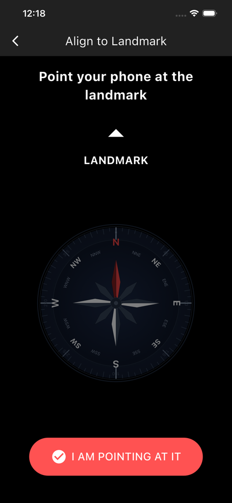 Geom Compass app calibration screen showing a compass and instructions to align the phone with a landmark