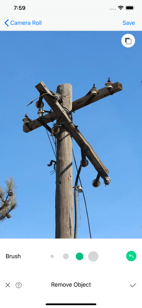 Interface of the Object Removal Pro app showing a photo of a wooden utility pole against a clear blue sky ready for editing with a brush tool