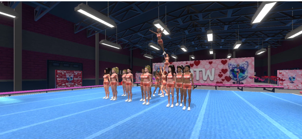 Boss of the World - Une simulation numérique d'une équipe de cheerleading All-Star effectuant une figure de haut niveau sur un tapis bleu à l'intérieur d'une salle d'entraînement.