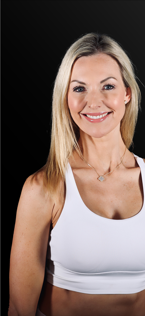 The Class Plan - Portrait of smiling Pilates instructor Korin Nolan wearing a white sports bra