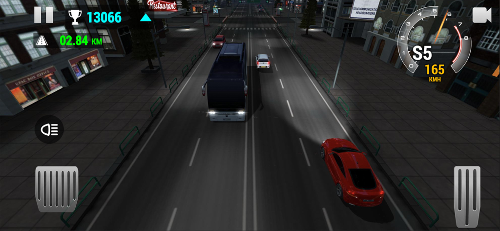 A red sports car driving through city traffic at night on a multi-lane highway in Racing Limits.