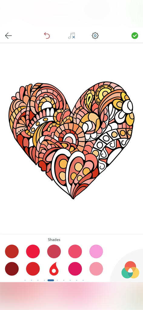 Heart shaped mandala with red and orange colors in a digital coloring app