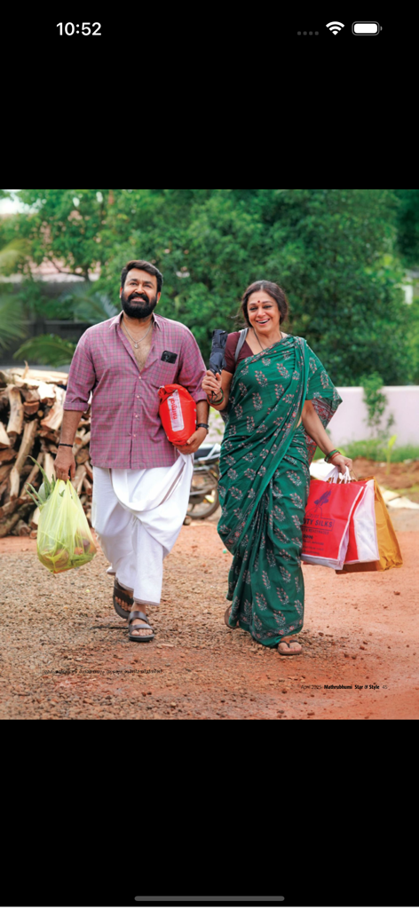 Star & Style - Malayalam cinema actors Mohanlal and Shobana in traditional Kerala attire walking with shopping bags