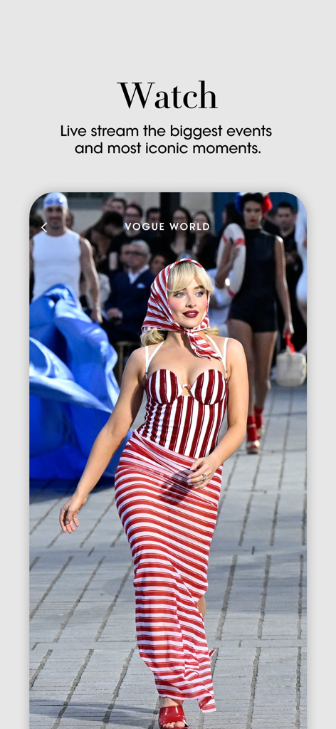 A fashion model walking on a runway during a Vogue World live event