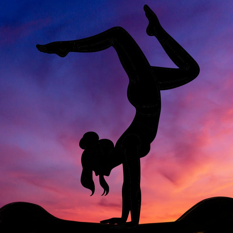 a woman doing a handstand