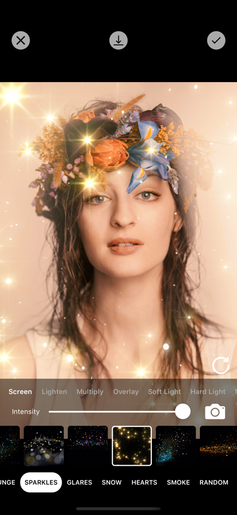 Photo Filters + - Portrait of a woman with a floral crown and glowing sparkle effects applied using a photo editing app
