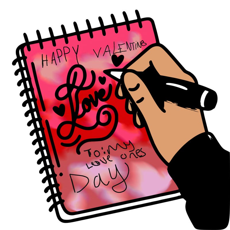 a hand writing “love” in calligraphy on a notebook