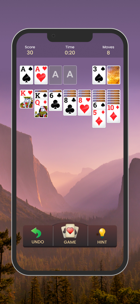 A game of Solitaire displayed on a smartphone with a beautiful nature background