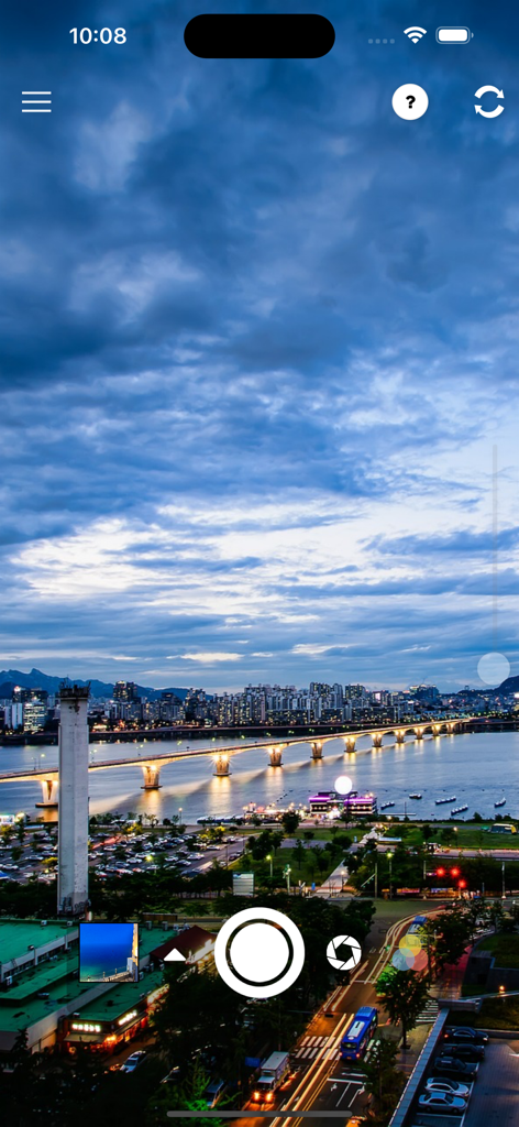 TAPCA - TAPCA camera app interface showing a night cityscape photo with a bridge and manual control icons.