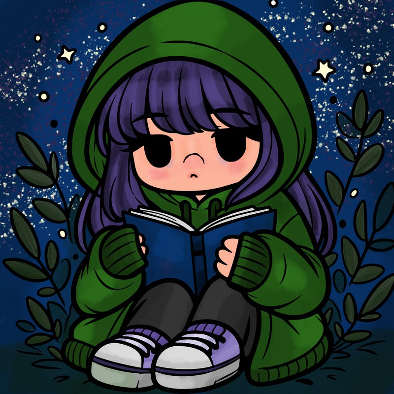 girl in oversized hoodie reading a book