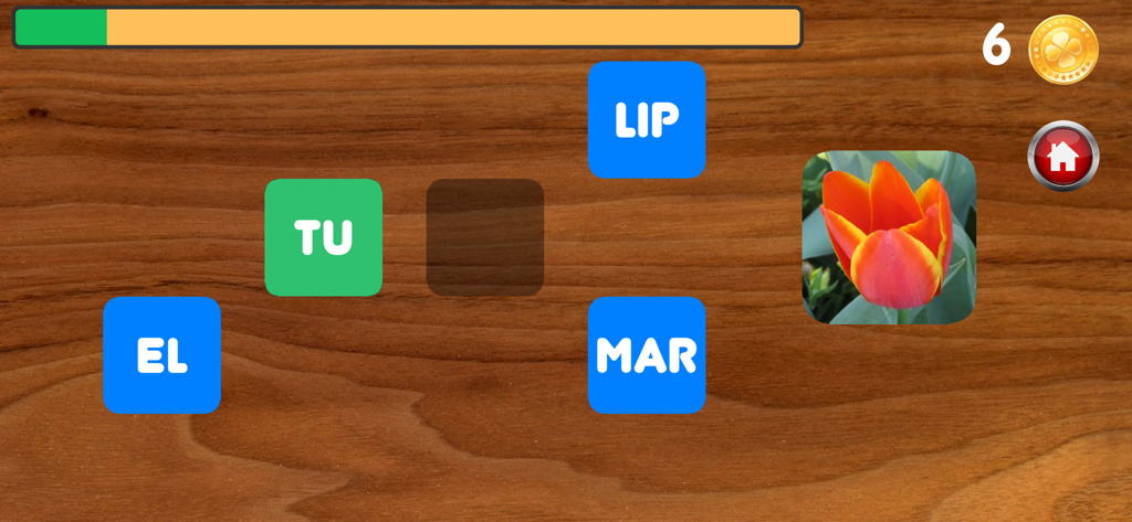 Writing with syllables - Pantalla de un juego de ortografía donde un niño completa la palabra tulipán seleccionando las sílabas correctas.