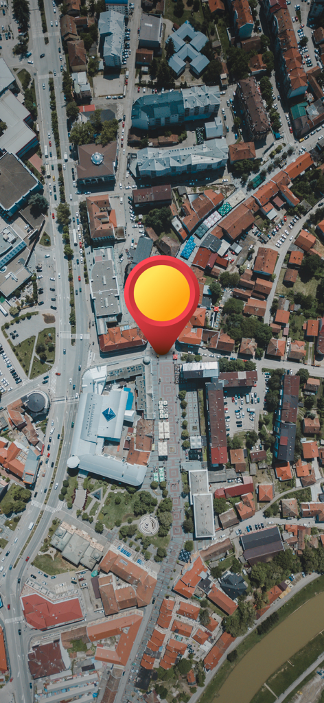 Street Map Live 3D Camera View - Top down aerial satellite view of a city with a large red map pin marker indicating a location.