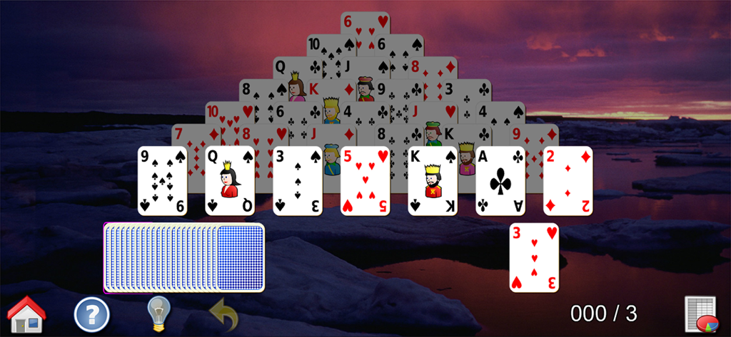 Gameplay of Pyramid Solitaire with large cards and a sunset landscape background