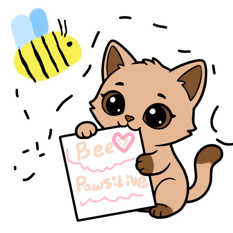 a small cat with a blank sheet of paper in its hand. the cat is sooooooo cute!