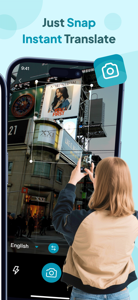 Owl Translator - A person using the camera feature of Owl Translator to translate a billboard sign in an urban setting.