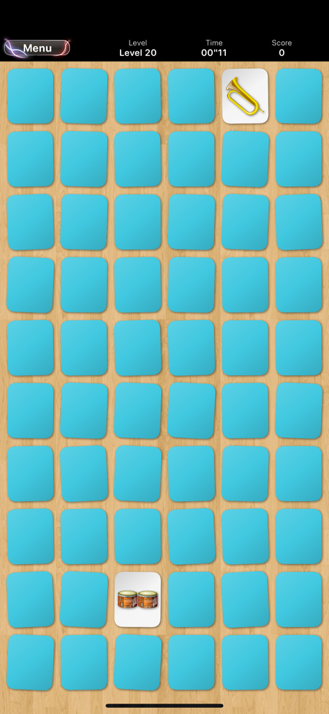 Gameplay of Memory Classic featuring a large card grid on a wooden background.