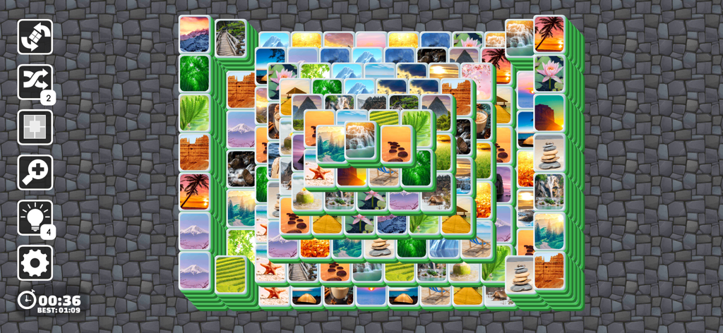 Mahjong Joy - Solitaire Tiles - Gameplay screen of Mahjong Joy Solitaire featuring tiles with nature landscape images on a stone background.