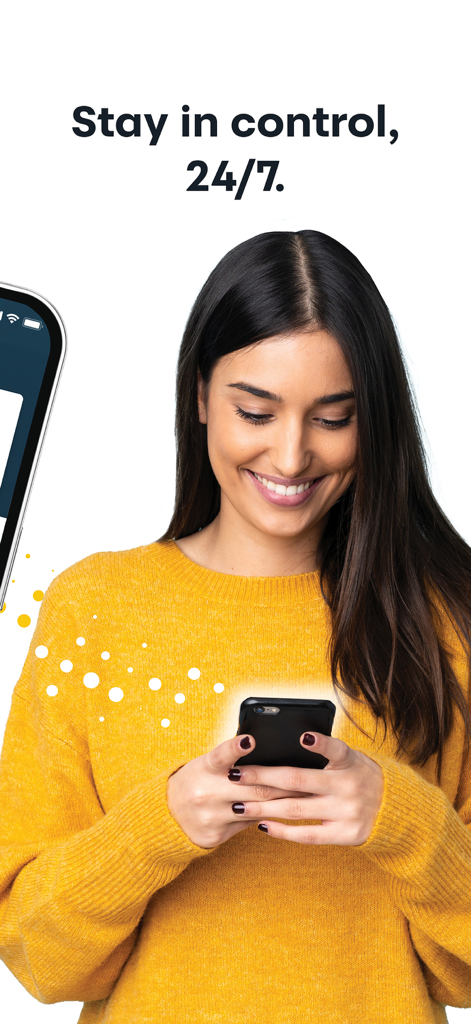 A woman smiling while managing her credit cards on the MySynchrony mobile app