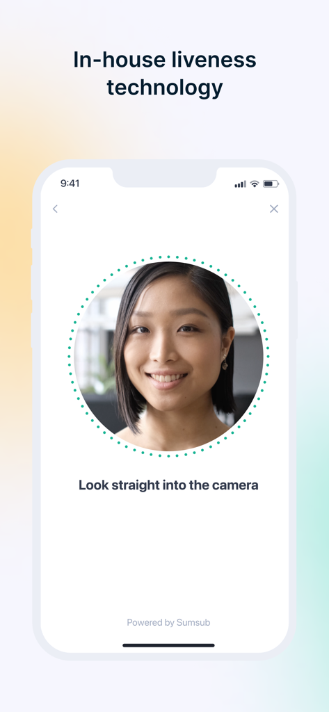A mobile interface showing the Sumsub liveness check technology for identity verification with a user looking into the camera