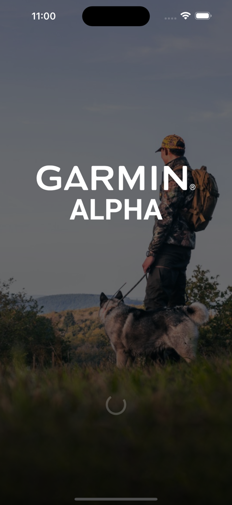 Garmin Alpha - Écran de démarrage de l'application Garmin Alpha montrant un chasseur avec son chien dans un décor extérieur montagneux