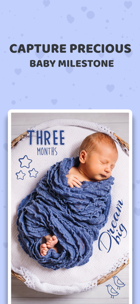 A newborn baby wrapped in a blue blanket with three months and dream big decorative stickers