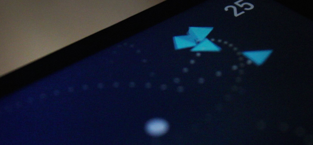 A close-up of the EMC game showing blue triangular particles moving along dotted paths against a dark background with a score of 25.