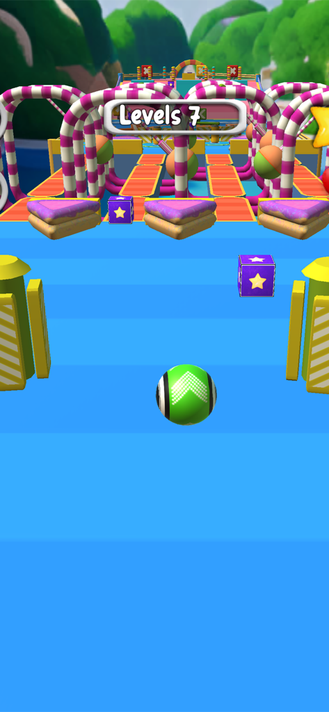 Rolling Ball Sky Escape Game - A green ball rolling on a blue track through colorful candy-themed obstacles in level 7