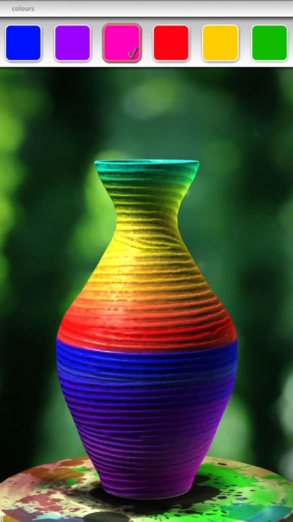 A 3D virtual ceramic vase with vibrant rainbow stripes being decorated in the pottery simulation app.
