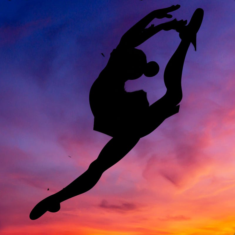 gymnast doing a leap in a leotard with a bent back leg