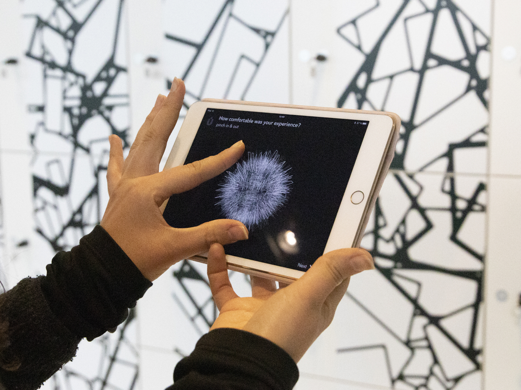 A visitor using a tablet to share their experience through the Muse interactive feedback app