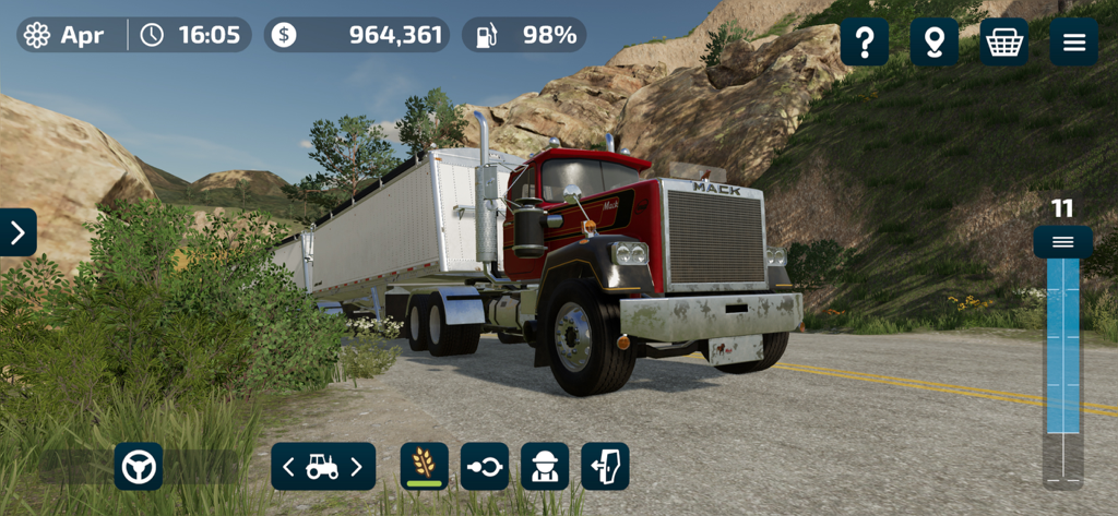 A red Mack truck with a white trailer driving on a scenic road in Farming Simulator 23 Mobile