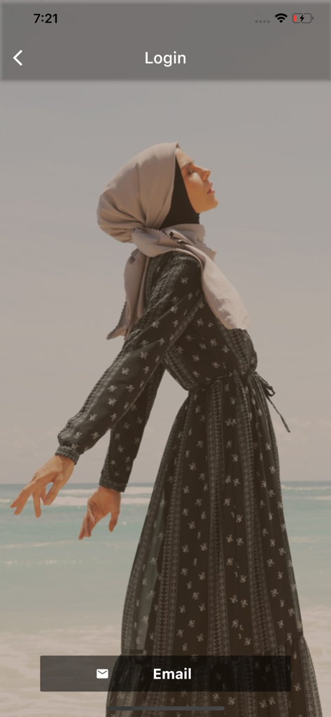 ZB - Zerina Banu login screen featuring a woman wearing a modest hijab and gamis dress at the beach.