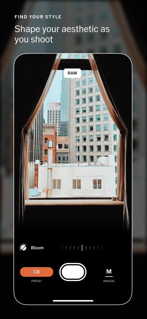 VSCO Capture: Photo & Video - VSCO Capture app camera interface showing a city view through a window with real time bloom effect and manual settings