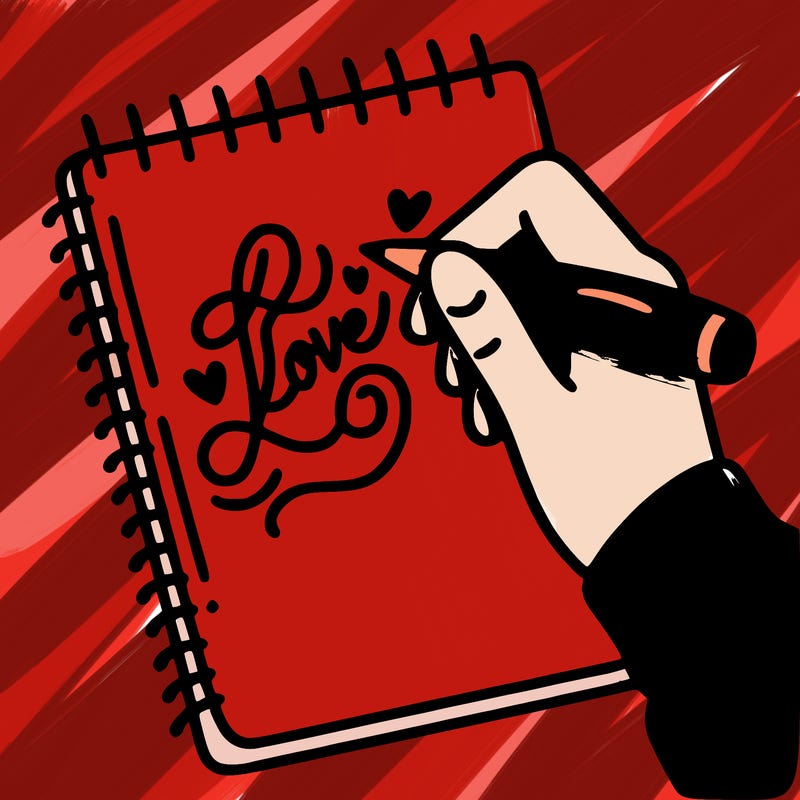 a hand writing “love” in calligraphy on a notebook