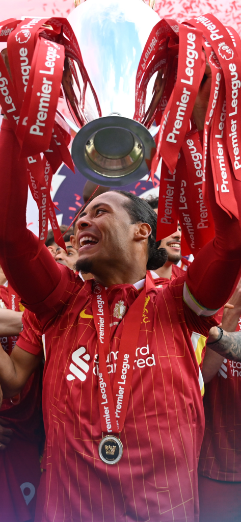 Liverpool player Virgil van Dijk lifting the Premier League trophy during a celebration