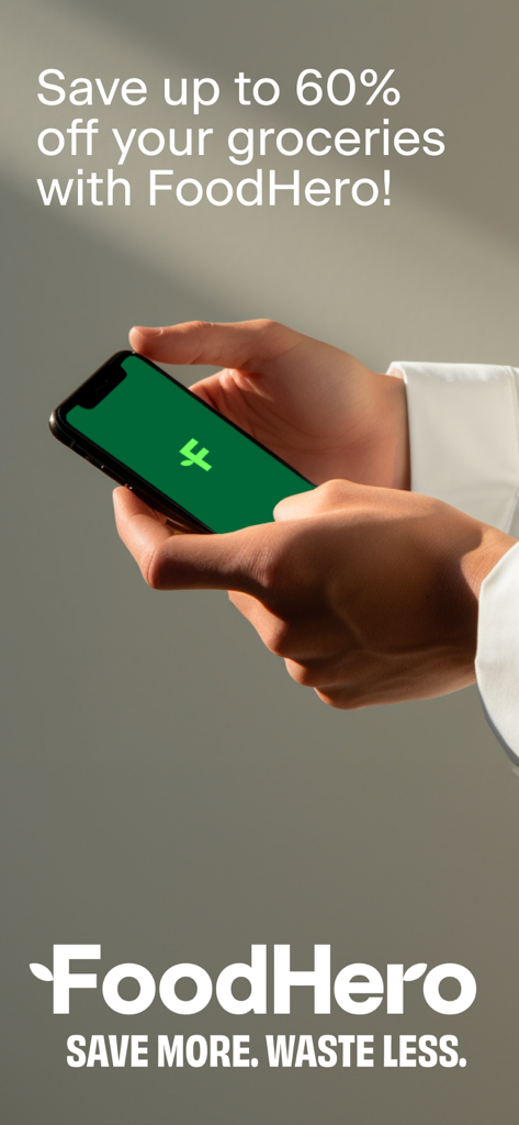 Hands holding a smartphone displaying the FoodHero app logo with text promoting up to sixty percent off groceries.